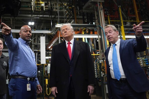 Trump gestures dismissively at heckler during visit to Detroit Ford plant